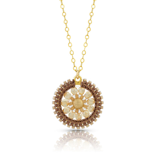 Delicate gold-filled chain gracefully suspends a macramé silk knotted medallion of glass beads and a beautiful gold center bead.