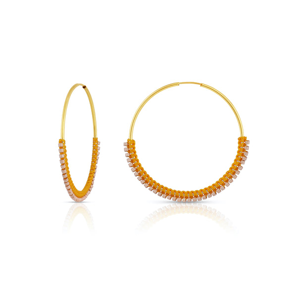 Lightweight and timeless, these gold-filled endless hoops are wrapped in color with tiny silk knots and glass beads. Intricate details, simplistic in shape.  Edit alt text