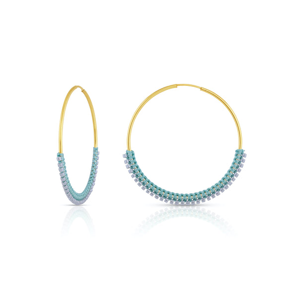Lightweight and timeless, these gold-filled endless hoops are wrapped in color with tiny silk knots and glass beads. Intricate details, simplistic in shape.  Edit alt text