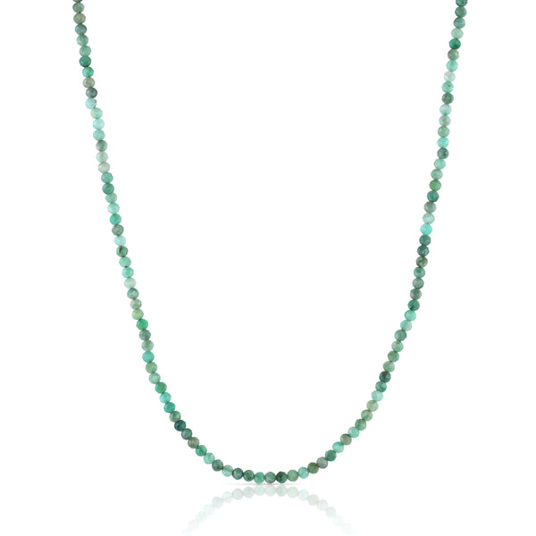 Inspired by the subtle, organic colors of an ocean shoreline, this classic beaded necklace features small, faceted emerald gemstones and a magnetic clasp